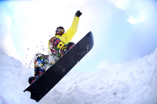 雪山でジャンプするスノーボーダー